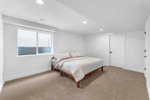 Carpeted room featuring a double window, recessed lighting, and white baseboards