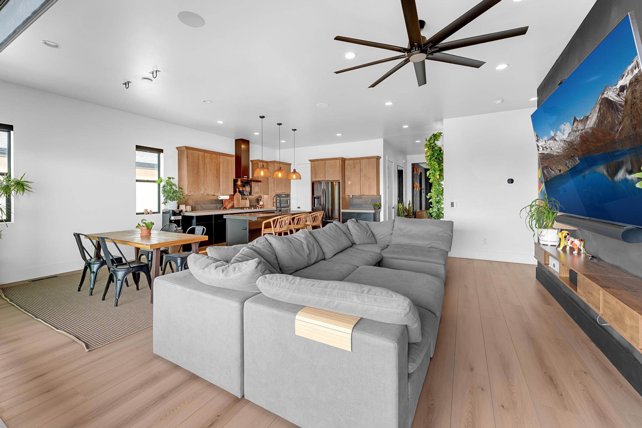 Open-concept living area featuring wood-finish flooring and recessed lighting