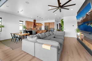 Open-concept living area featuring wood-finish flooring and recessed lighting