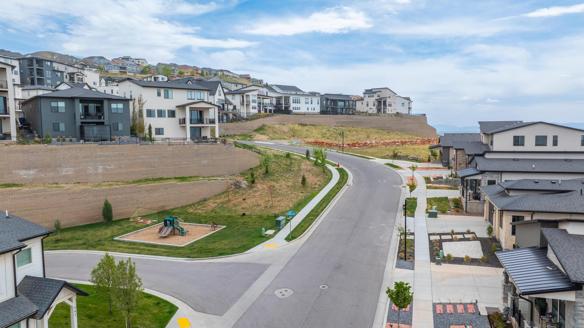 Modern residential development featuring multi-level homes with varied exterior finishes