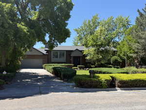Traditional brick exterior with a gray-toned roofline, an attached two-car garage, and a concrete driveway