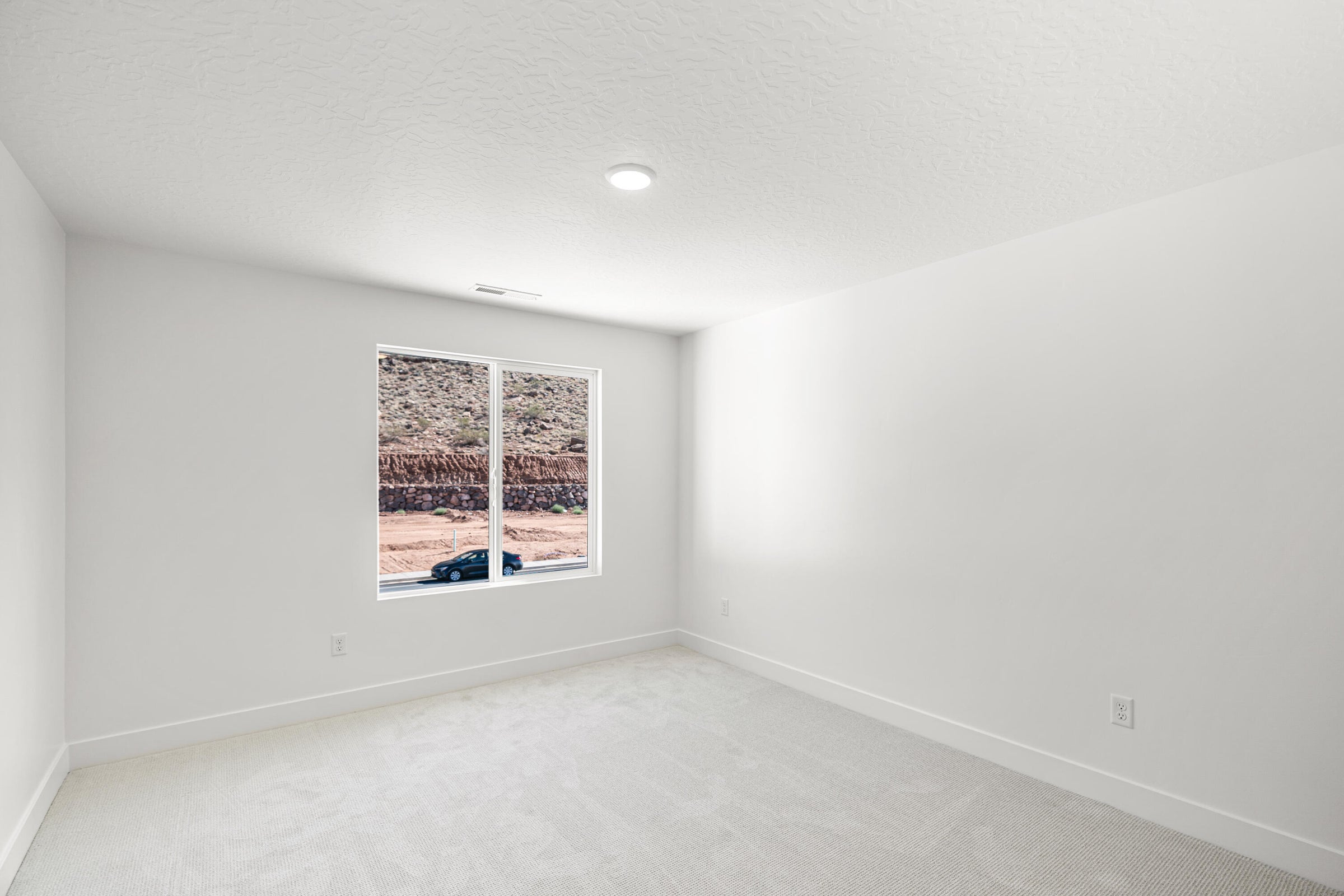 Room featuring light-colored carpeting, a single window, recessed lighting, and white walls