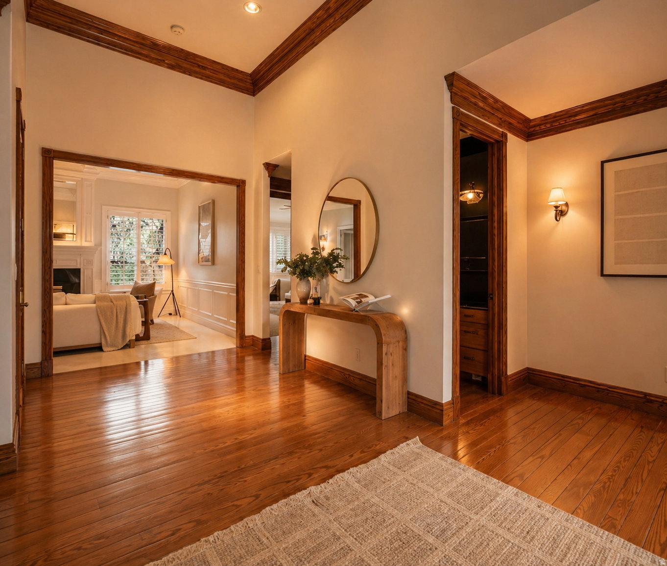 Hardwood flooring throughout the entry area, featuring crown molding and recessed lighting