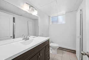 Modern bathroom vanity featuring a white countertop, undermount sink, and brushed nickel faucet