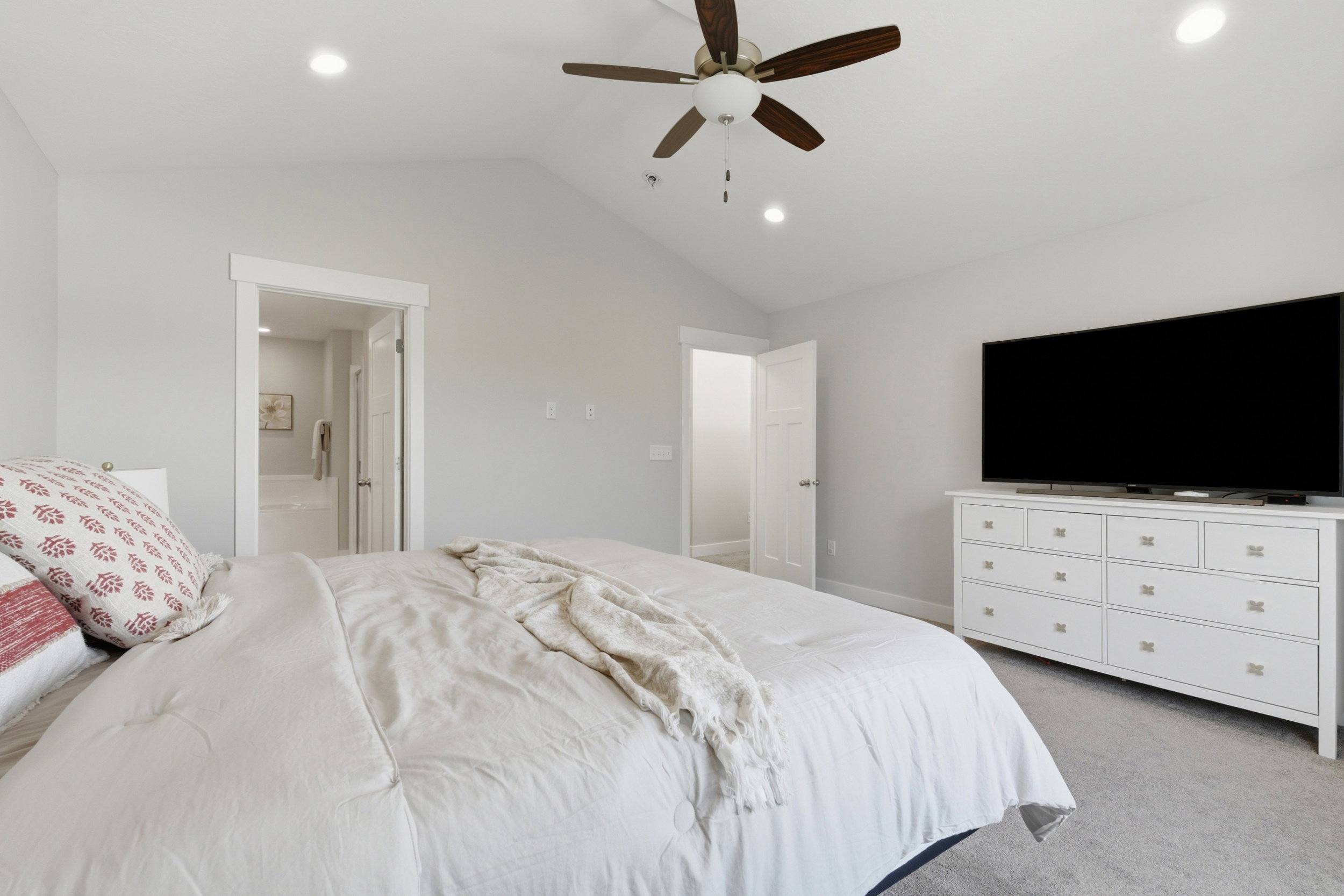 Vaulted ceiling bedroom featuring recessed lighting and a ceiling fan