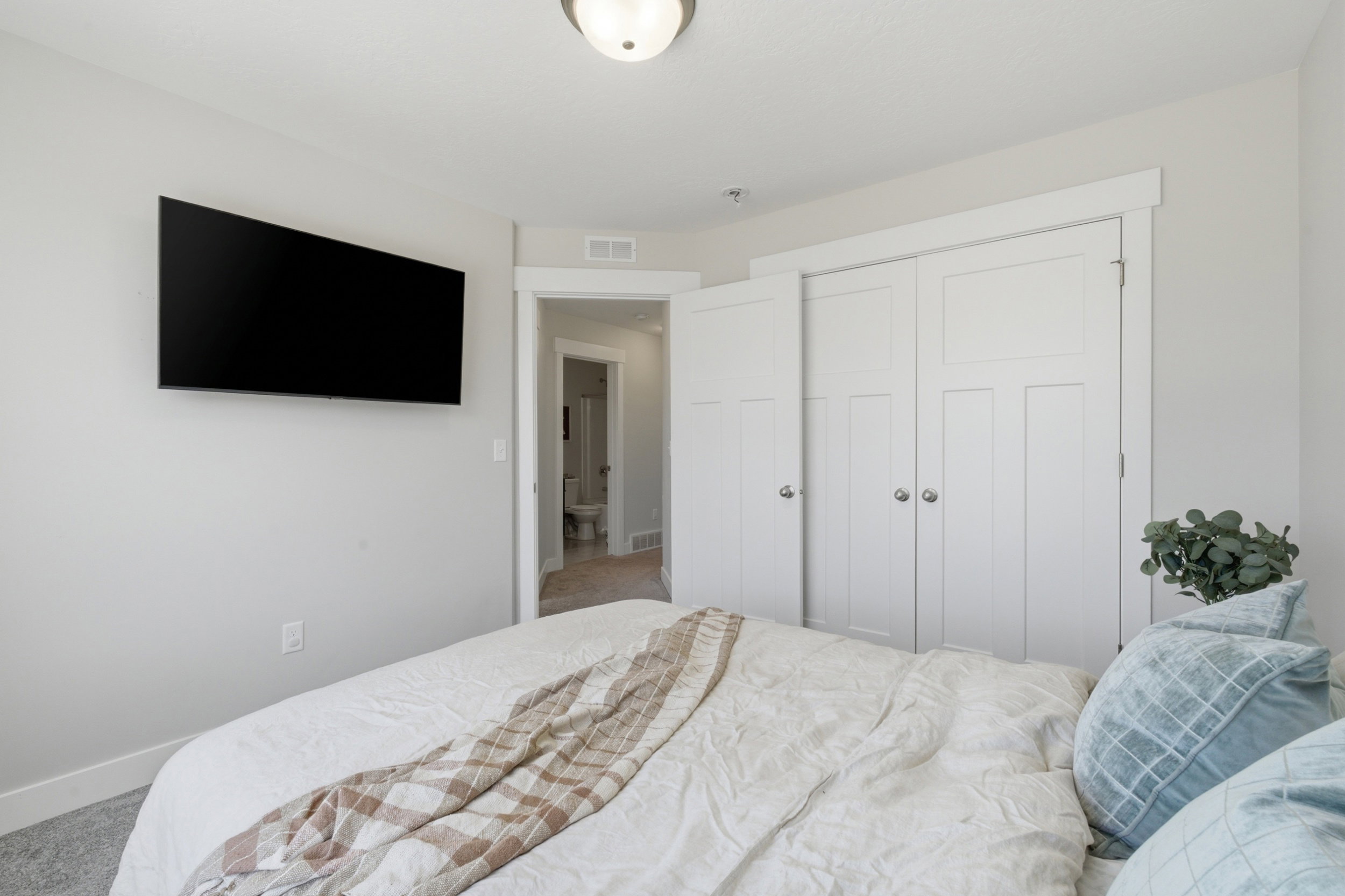 Bedroom featuring neutral wall paint, white trim, and light gray carpet