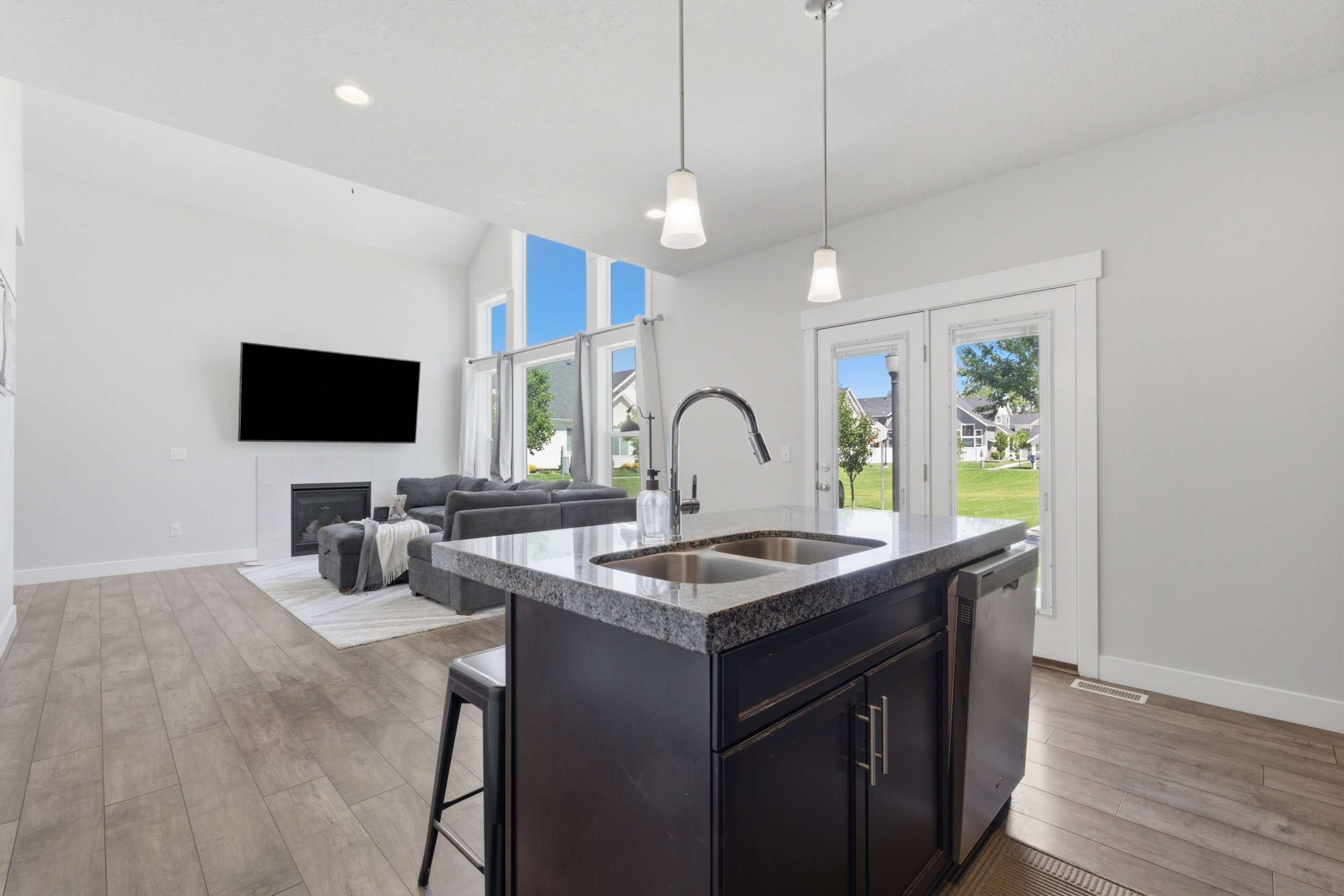 Kitchen island featuring a double-basin sink and stainless steel dishwasher