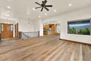 Expansive open-concept room with wood-finish flooring throughout