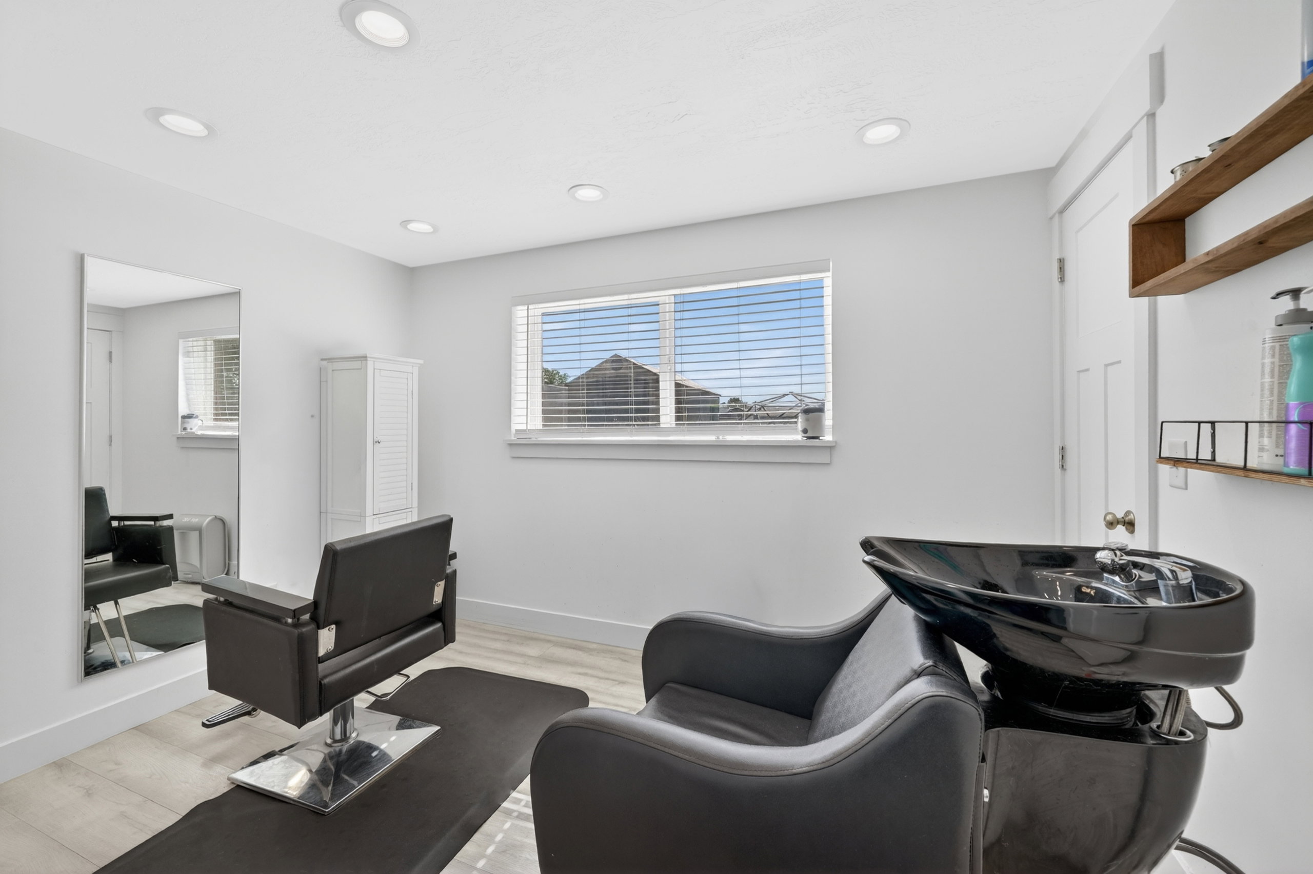 Bright room featuring recessed lighting, a window with blinds, wood-finish flooring, and white walls