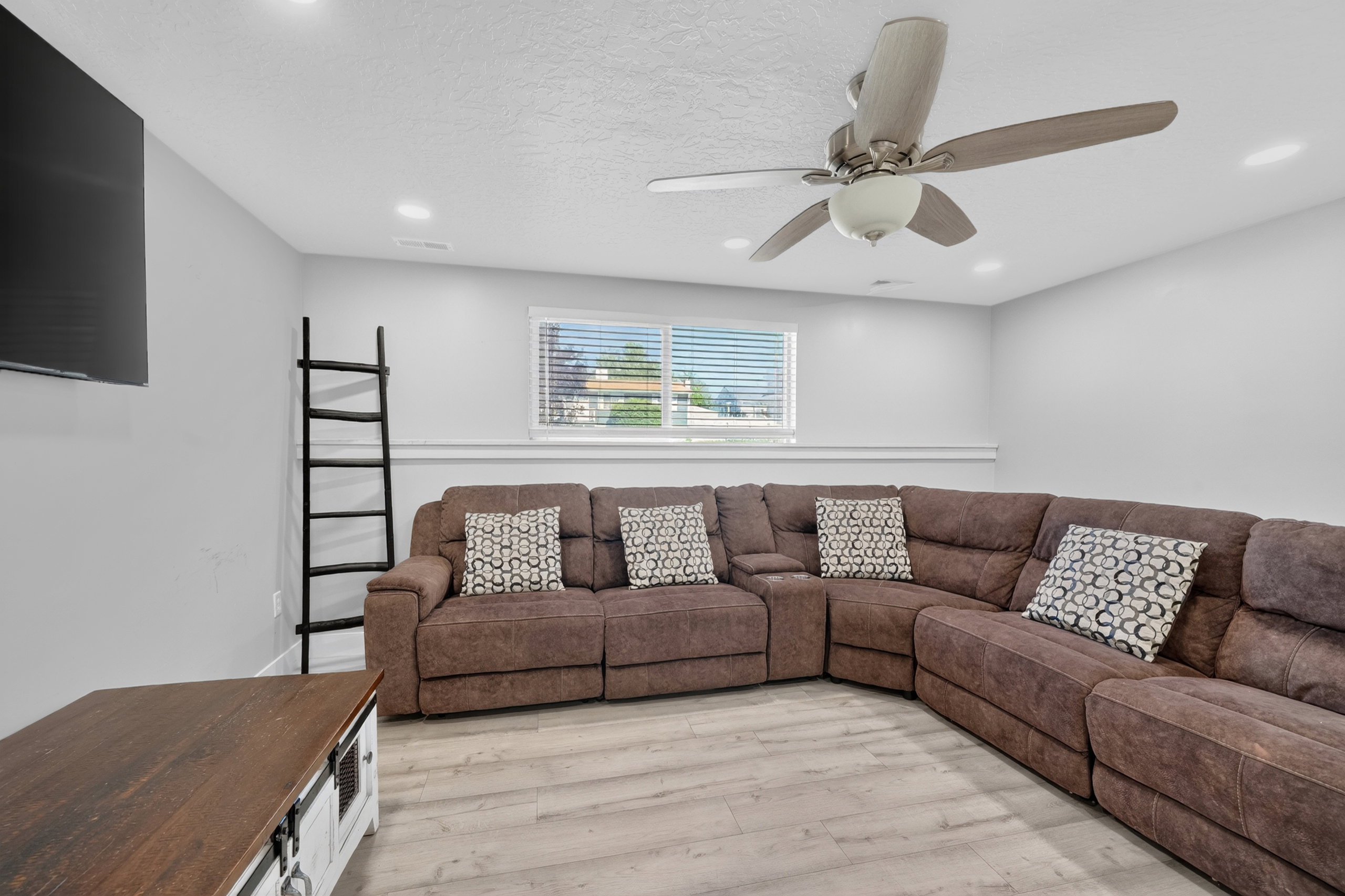 Spacious room featuring light-toned wood-finish flooring and neutral walls