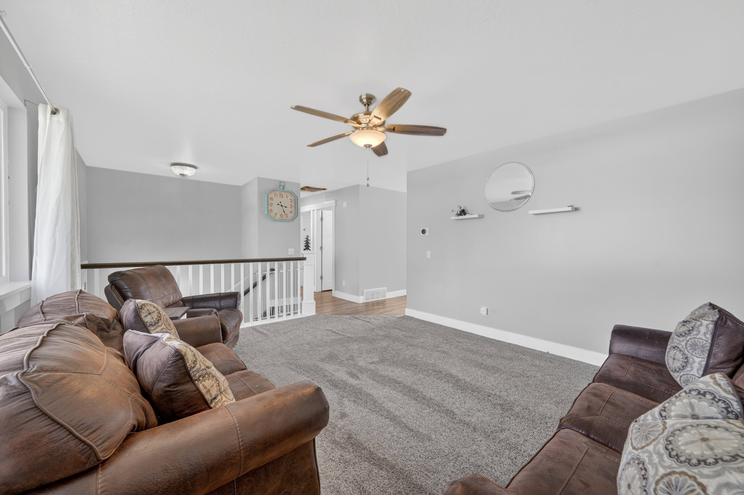 Upper-level lounge area featuring light gray wall tones and carpeting