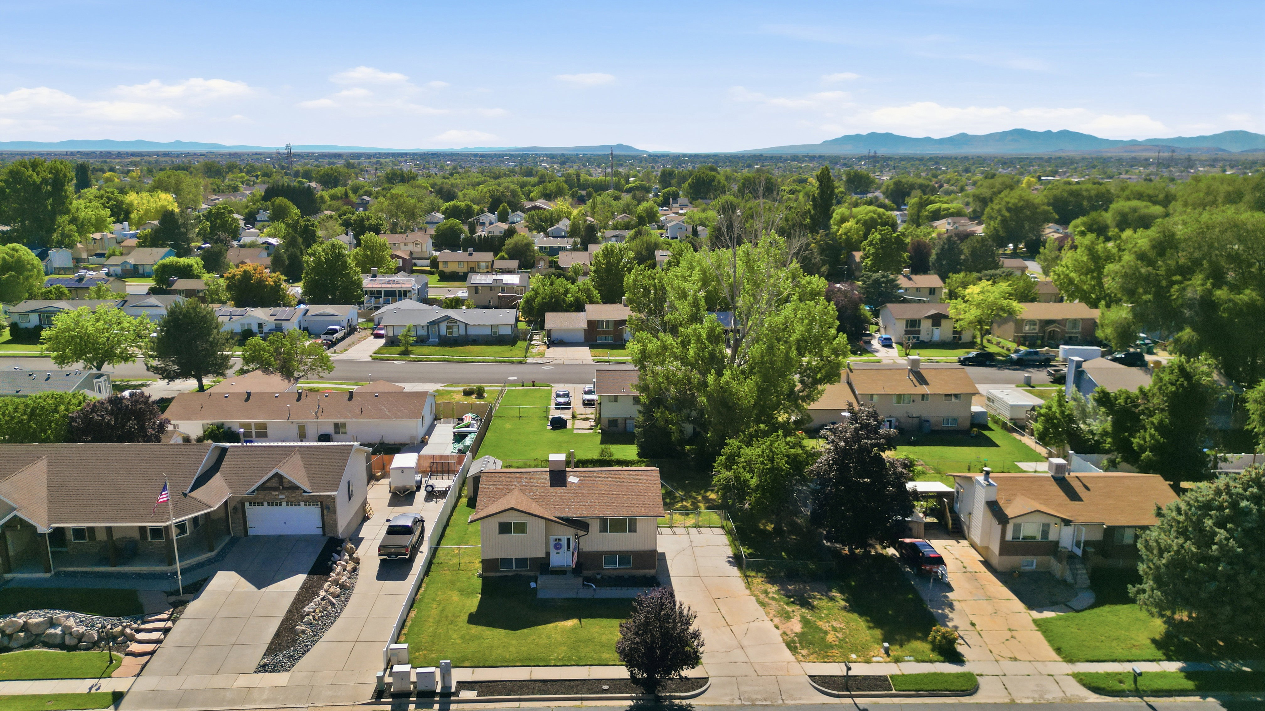 Residential neighborhood featuring single-family homes with pitched roofs and mature trees