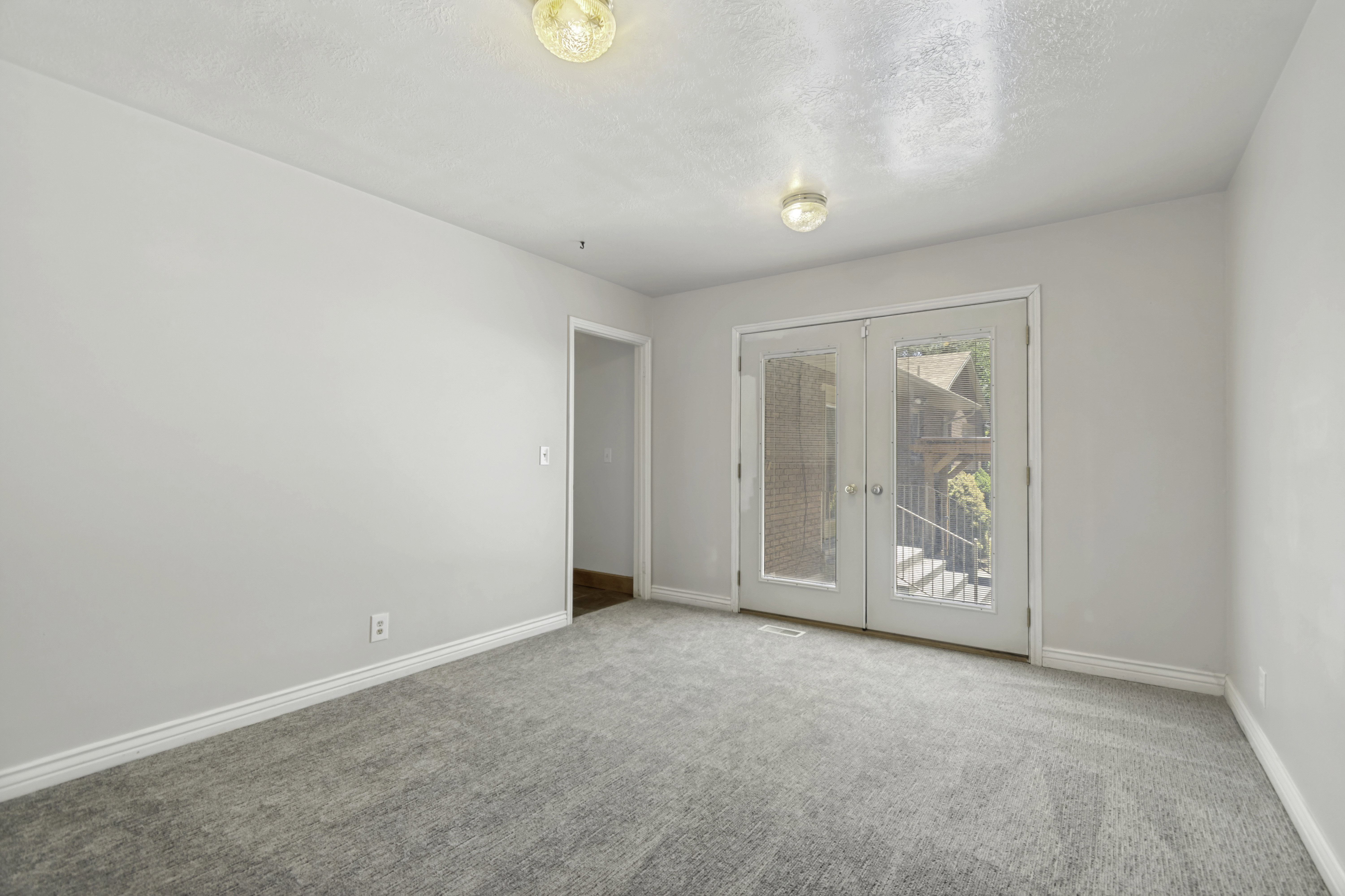 Room featuring light gray carpeting and white walls