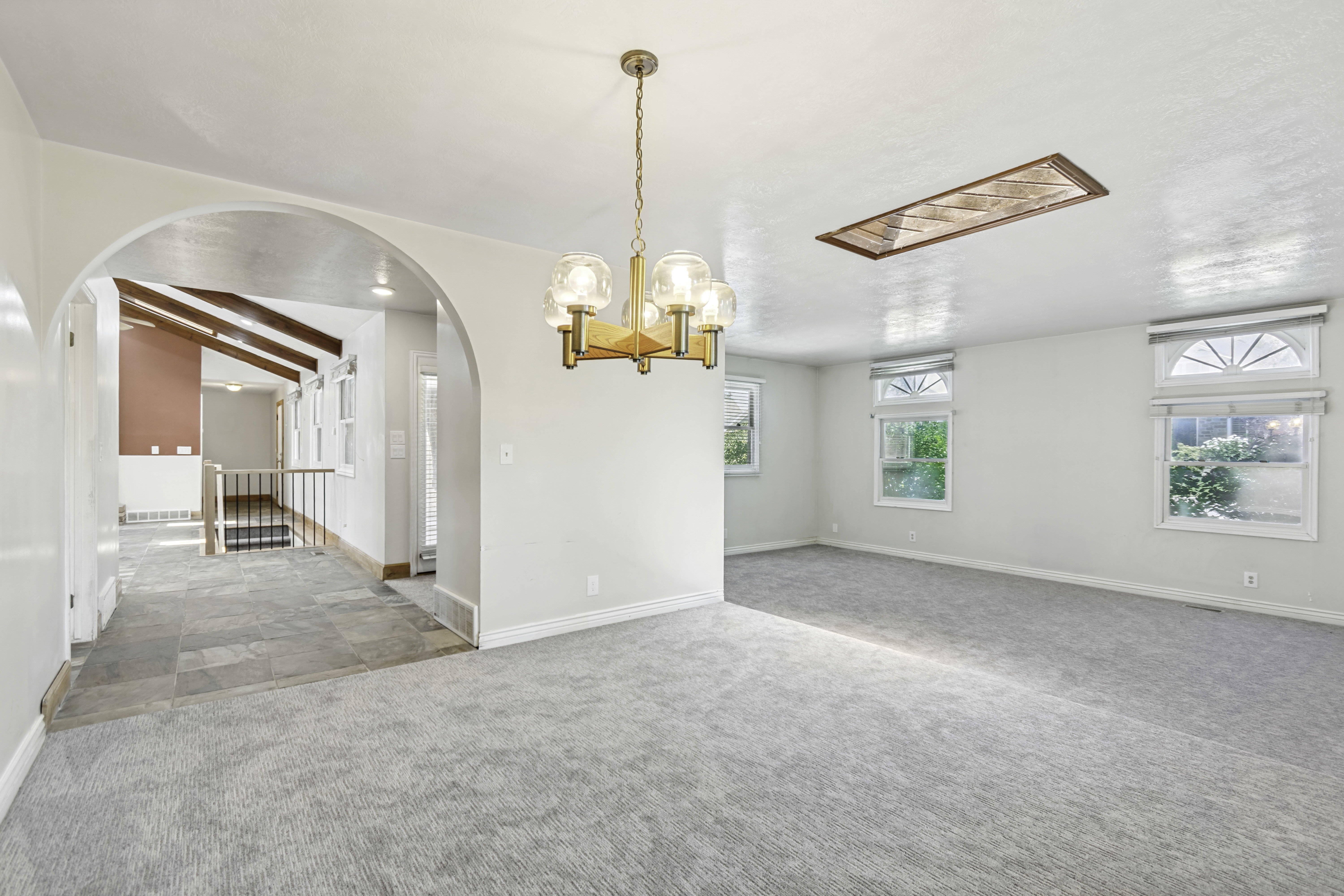 Bright room featuring light grey carpeting and multiple windows