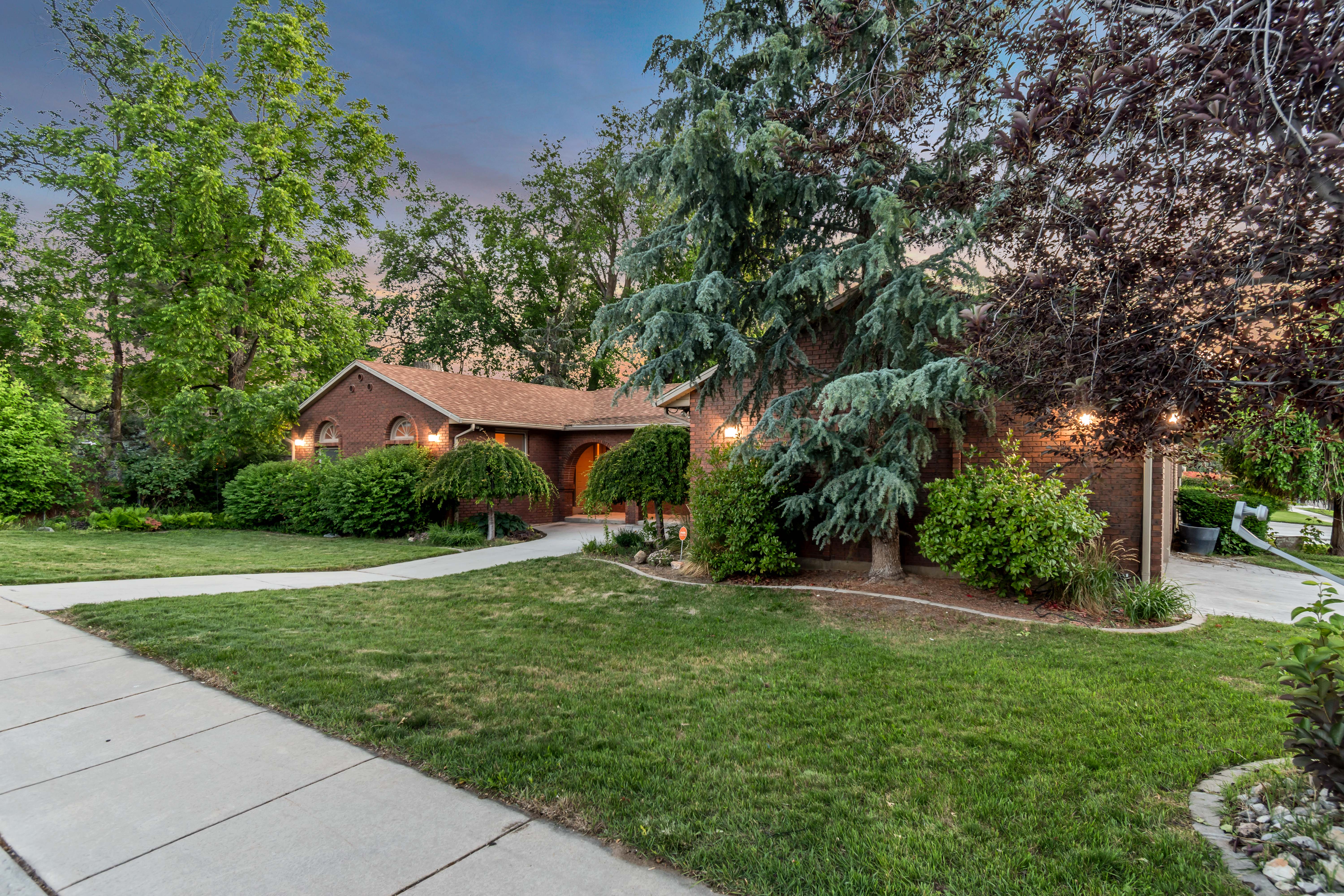 Brick exterior featuring arched windows and a front walkway