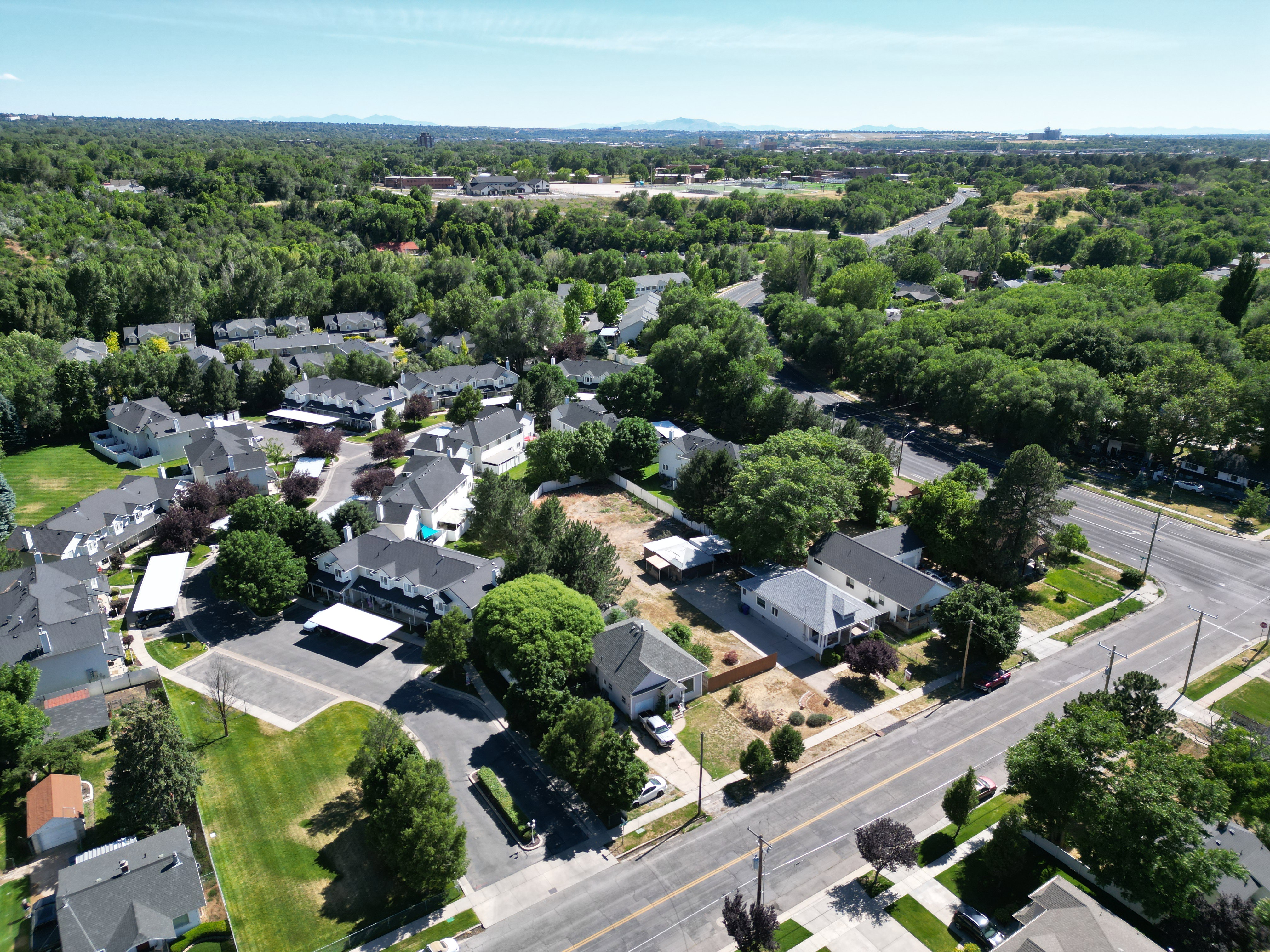 Aerial perspective showcasing a residential community with mature trees and paved roadways
