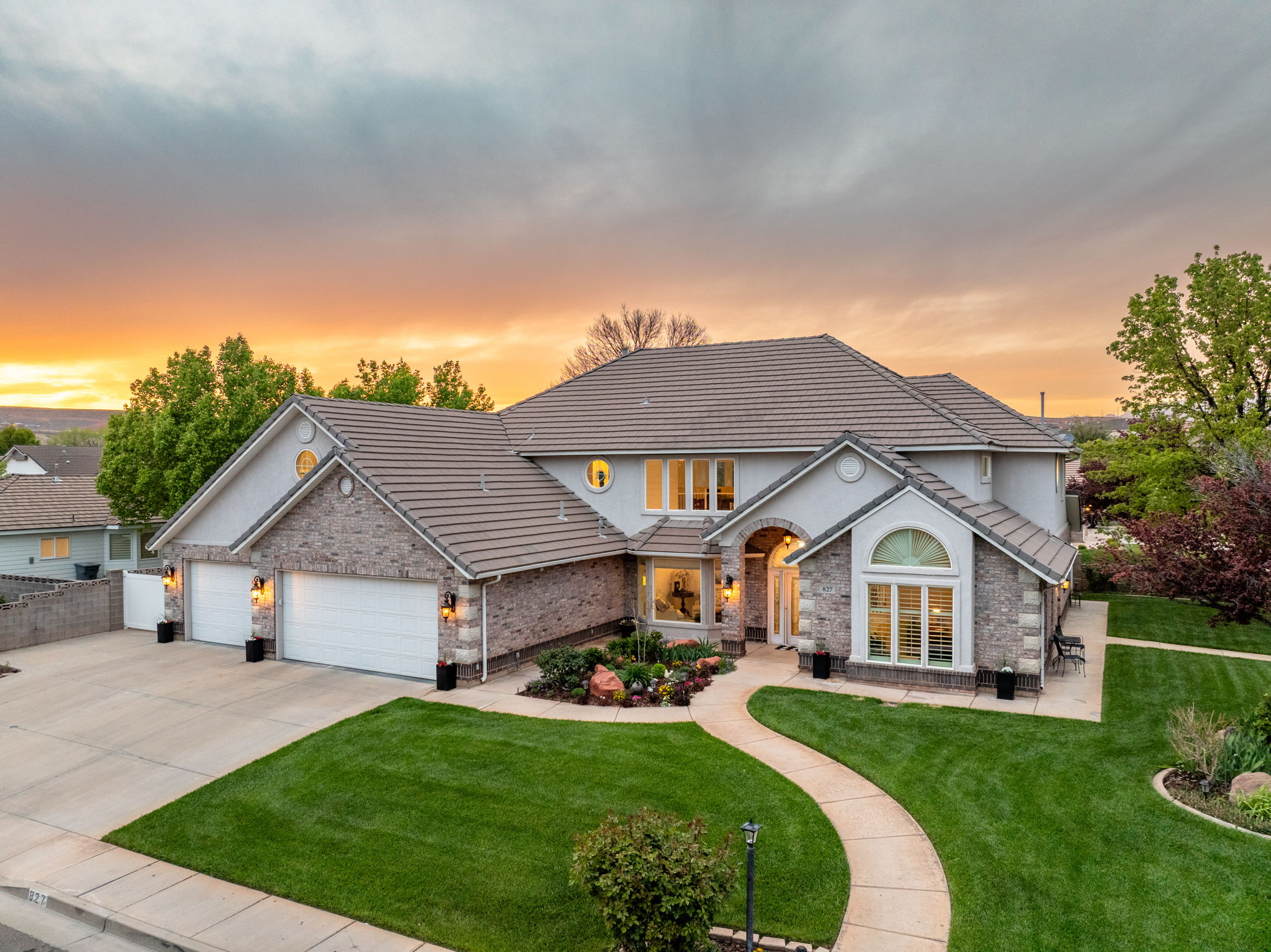 Stately residence featuring a multi-gabled roofline and a mix of stucco and stone veneer exterior