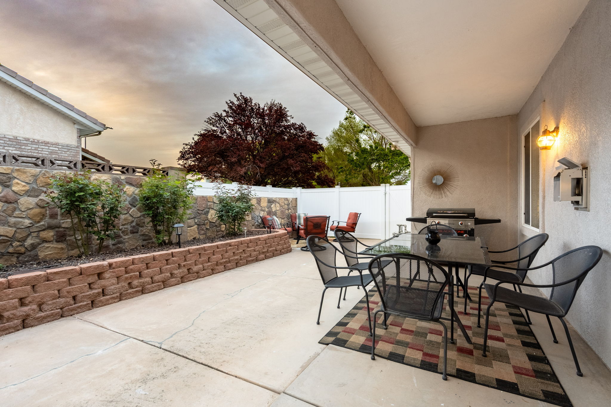 Covered patio with exterior lighting and a concrete slab