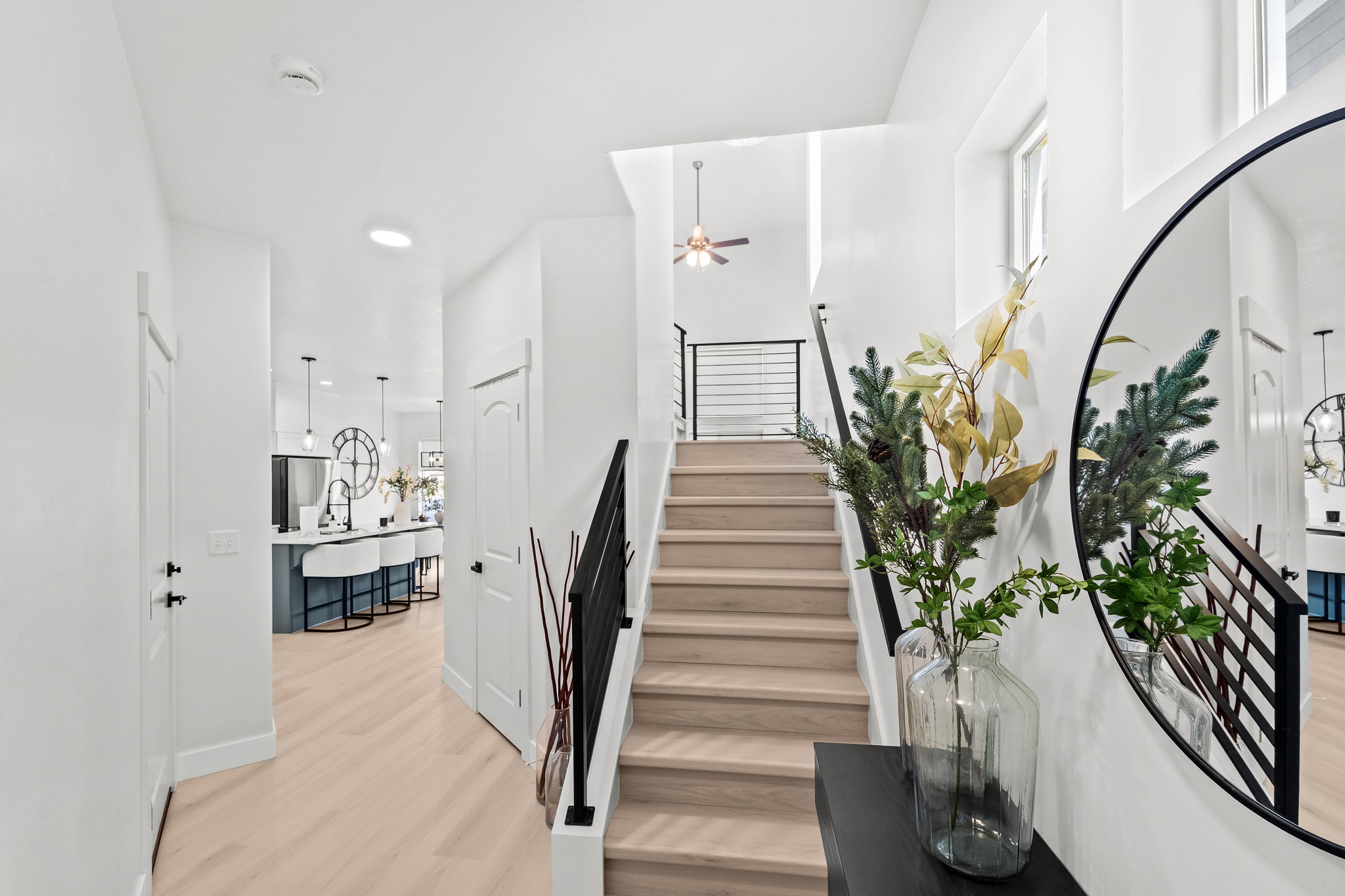 Staircase with light wood-finish treads and black metal railings