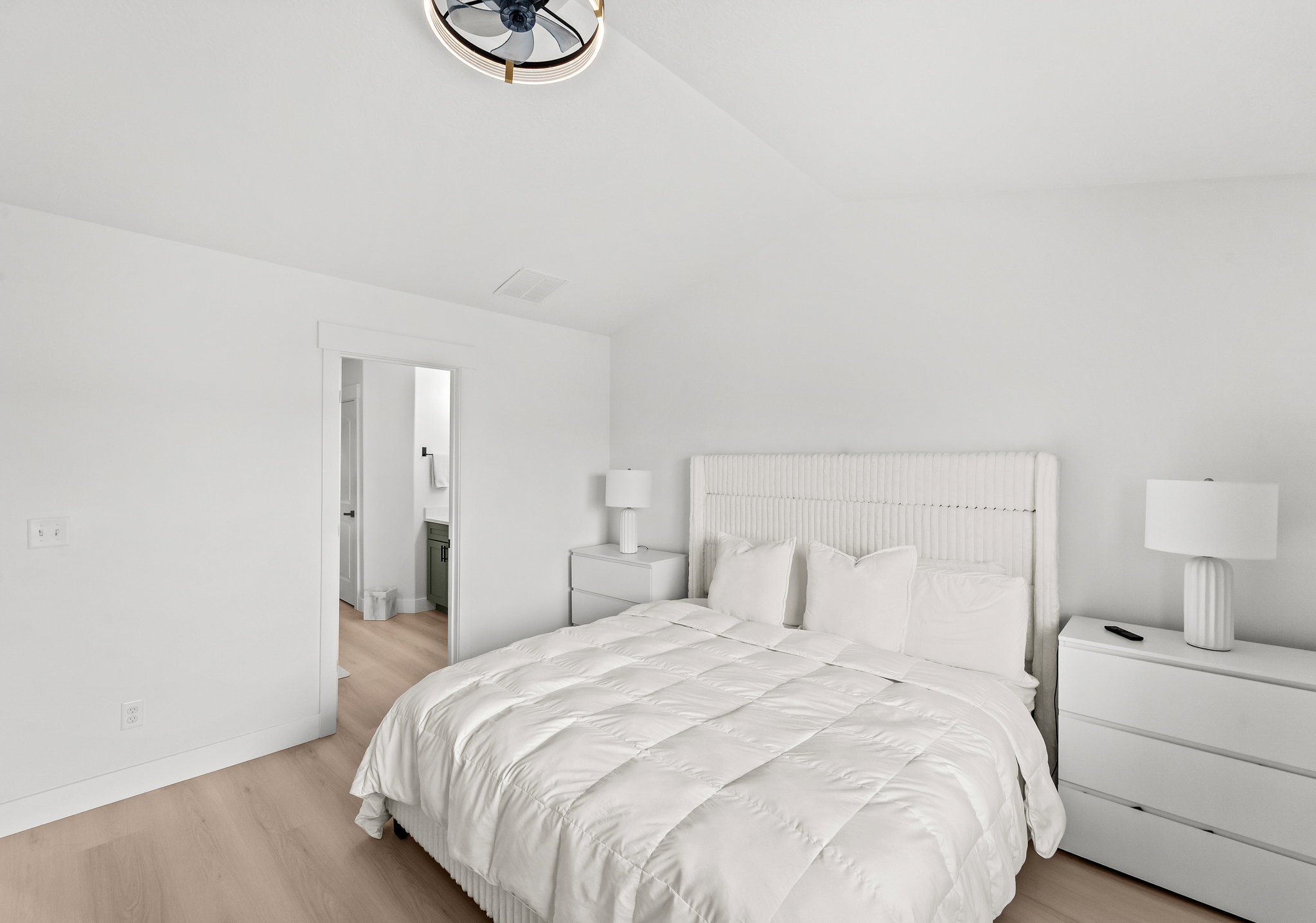 Light wood-finish flooring complements the crisp white walls