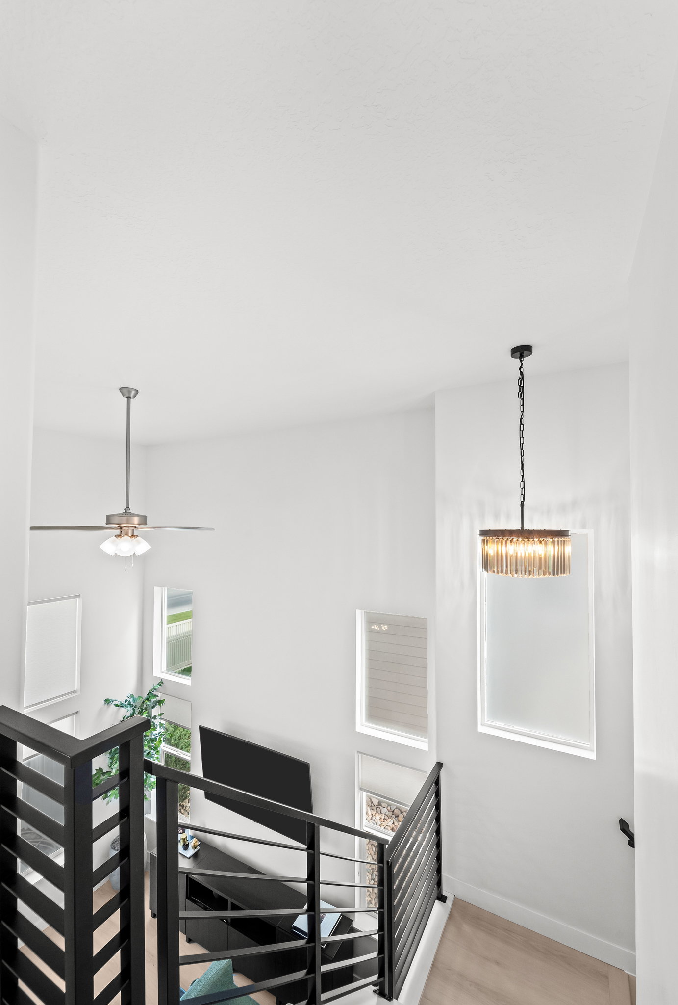 Spacious entry with high ceilings, multiple windows, and light wood-finish flooring