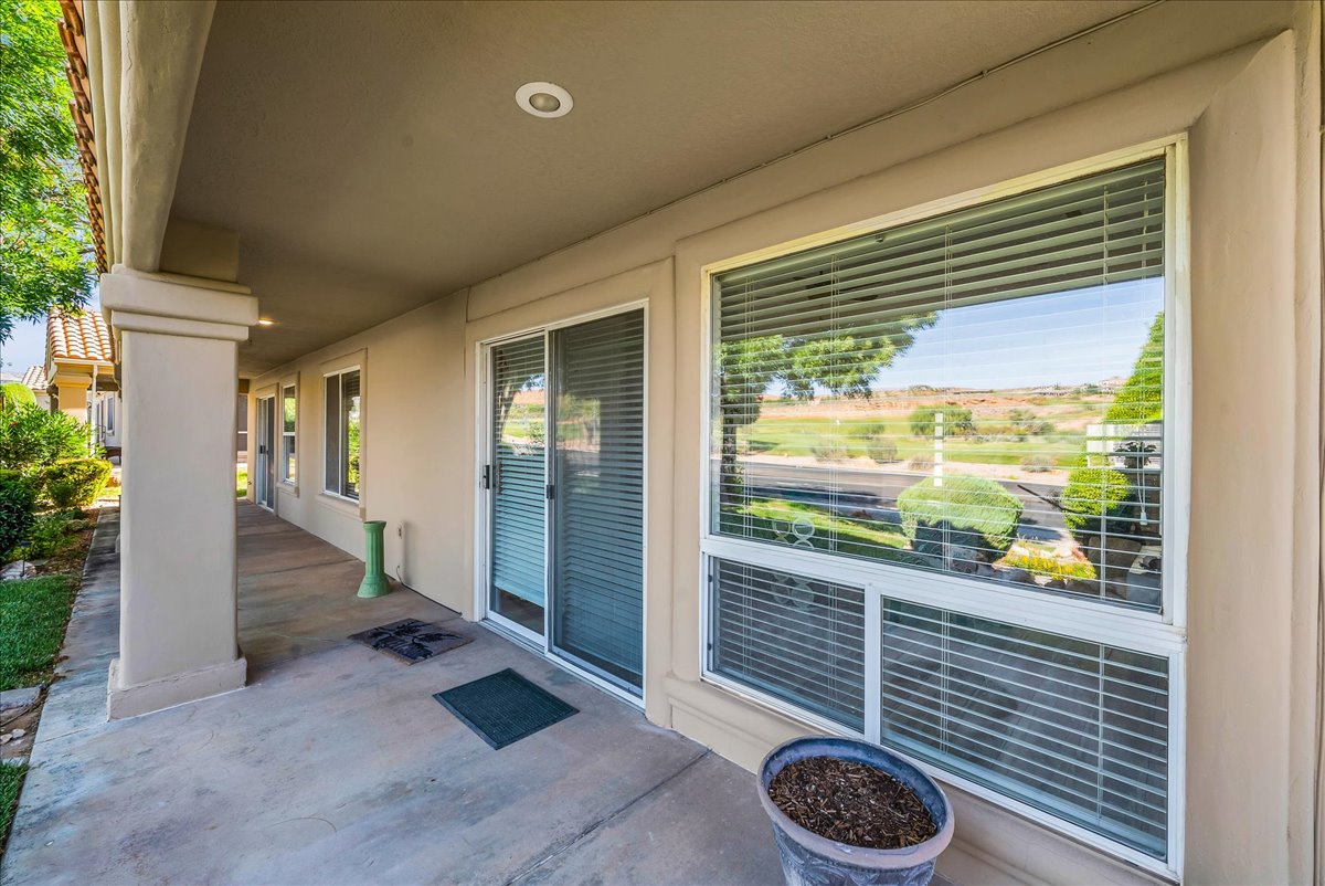 Concrete patio with stucco columns, recessed lighting, and a sliding glass door