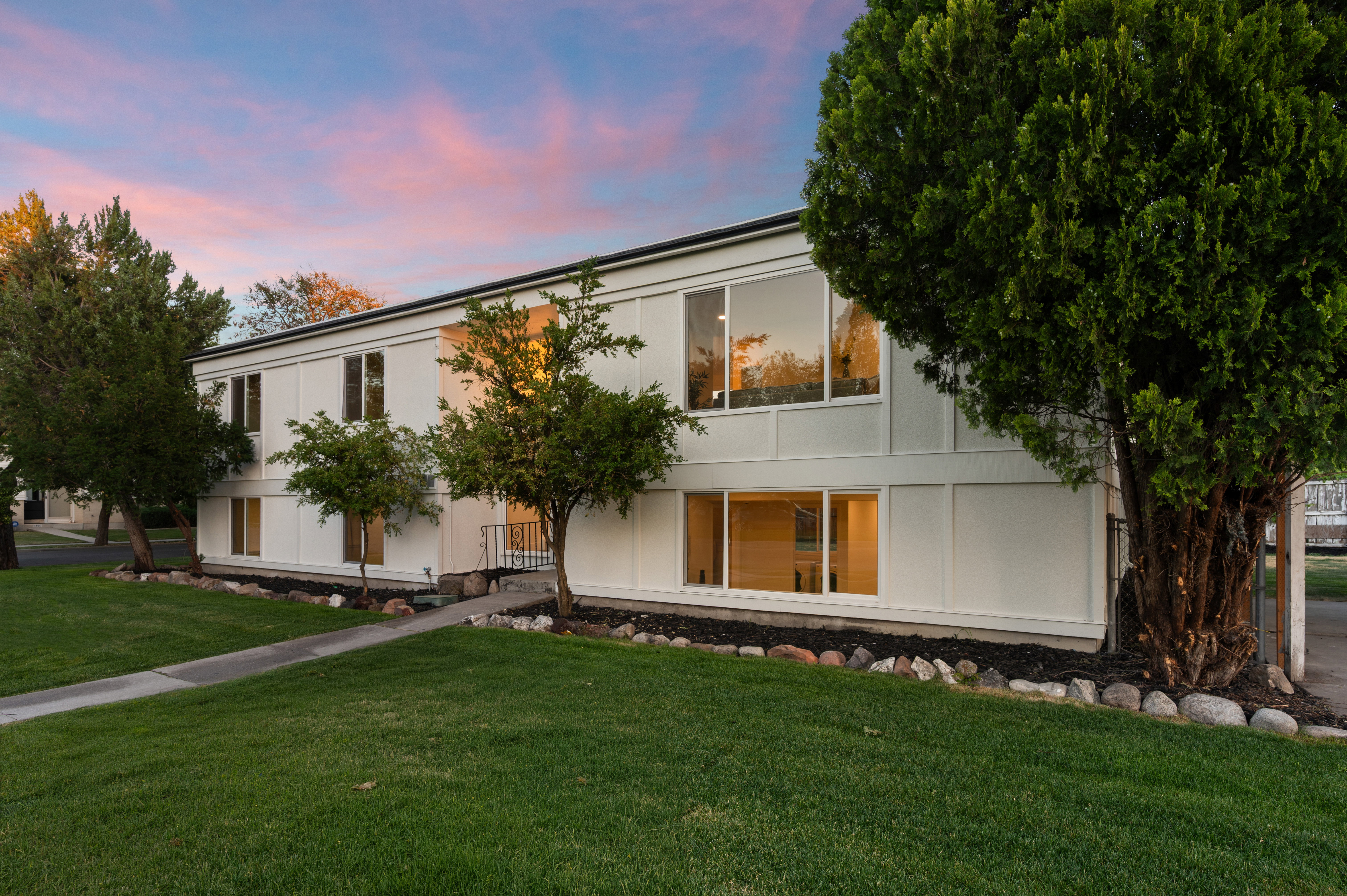 Two-story residential structure featuring a white exterior with black trim