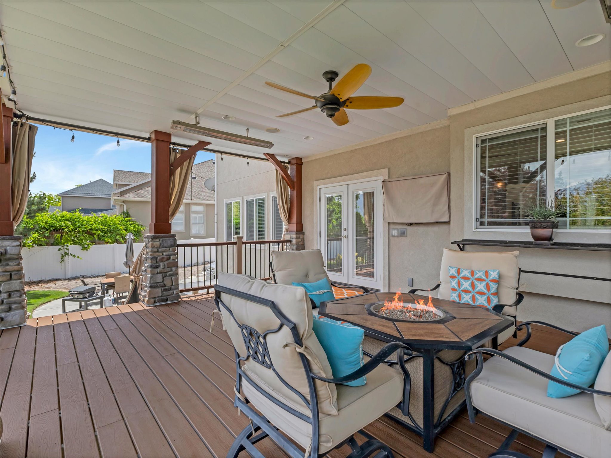 Main floor back deck off the kitchen with a fire pit and outdoor television.
