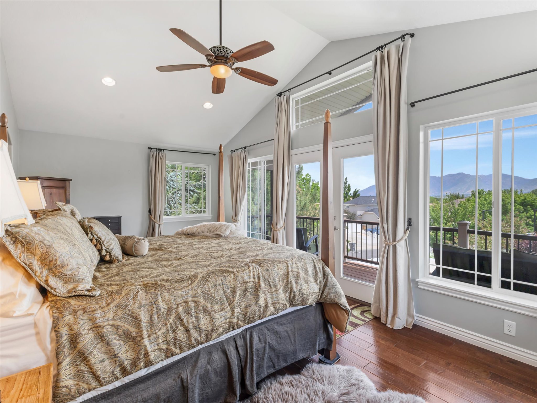 Primary suite bedroom with private balcony and mountain views.