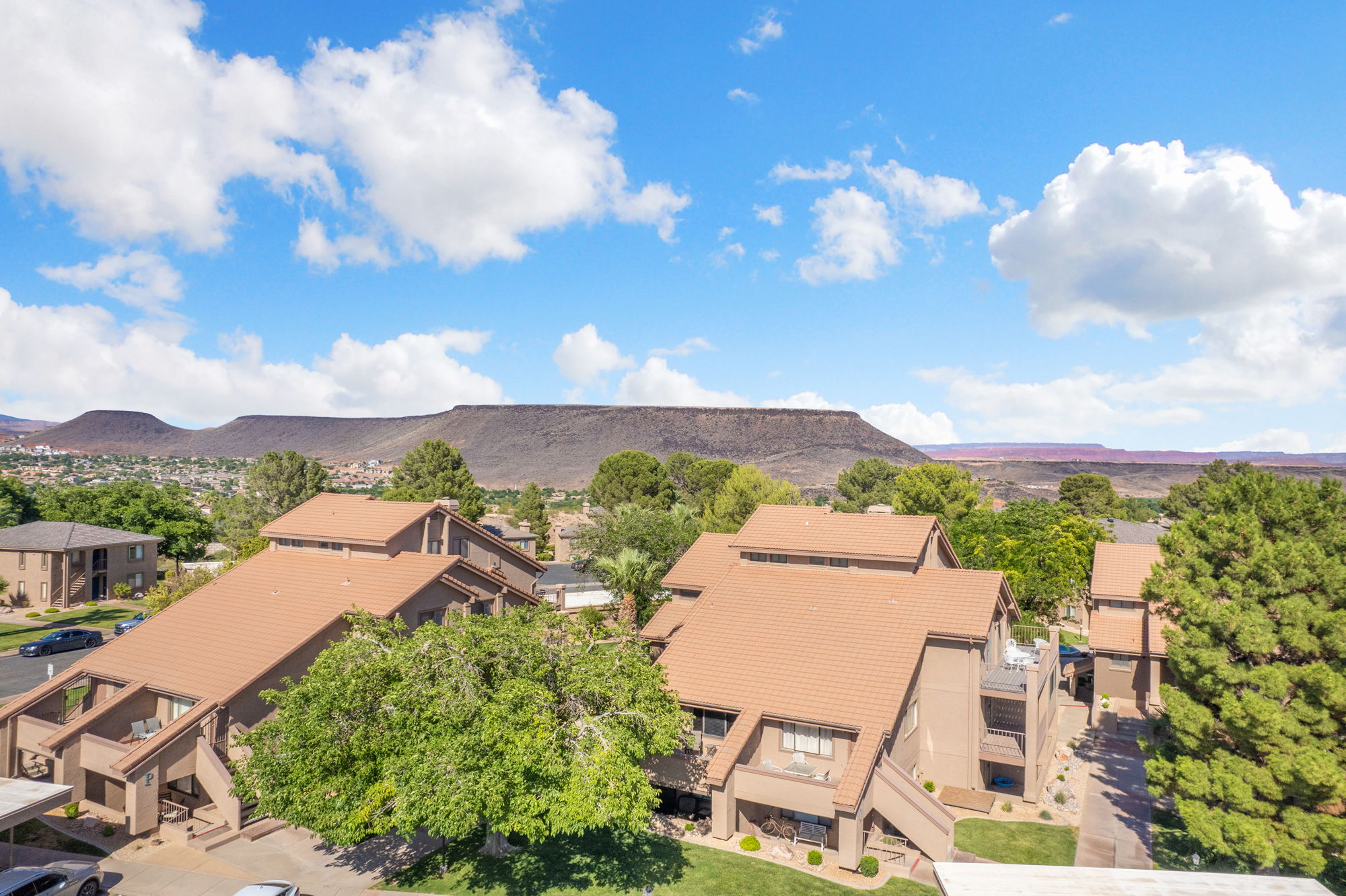 Multi-level residential structures featuring warm-toned stucco exteriors and tile roofing