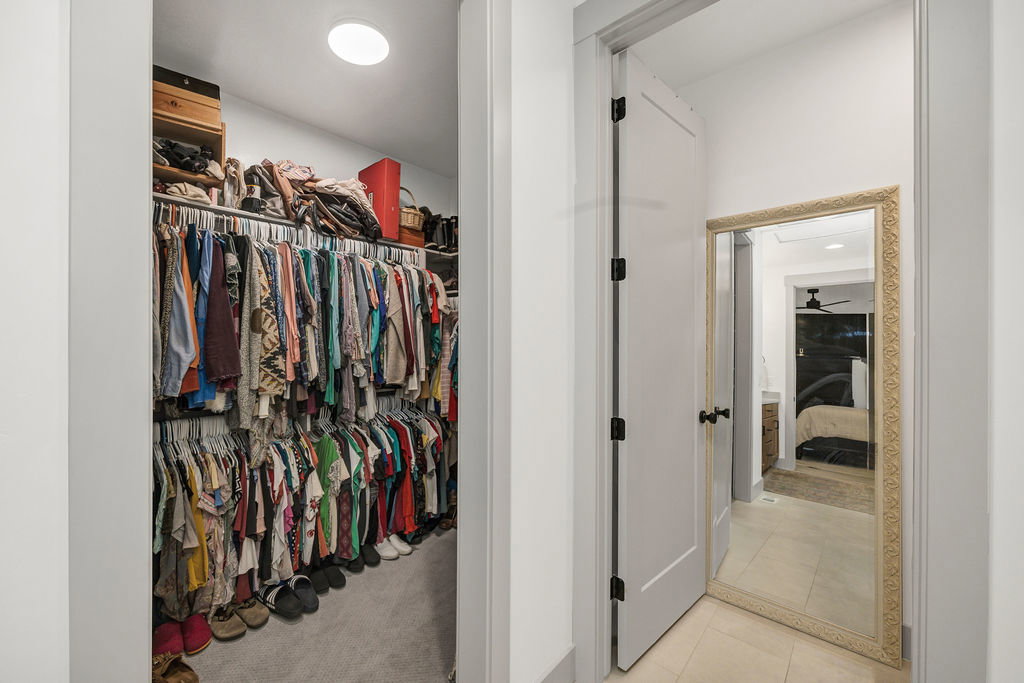 Walk-in closet with carpet flooring, recessed lighting, and dual-level hanging rods