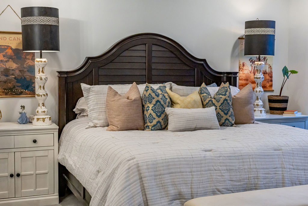 Dark wood headboard featuring a slatted design and curved top detail