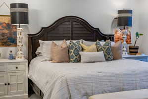 Dark wood headboard featuring a slatted design and curved top detail