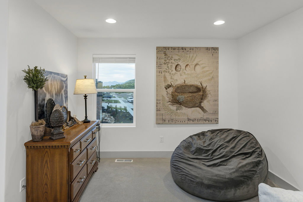 Bright room featuring a single window, recessed lighting, and light gray carpet