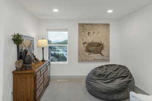 Bright room featuring a single window, recessed lighting, and light gray carpet