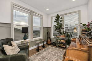 Room featuring wainscoting and wood-finish flooring