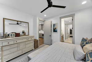 Recessed lighting and a matte black ceiling fan illuminate this interior space