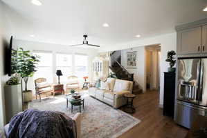 Open-concept living space with wood-finish flooring, recessed lighting, and a modern ceiling fan