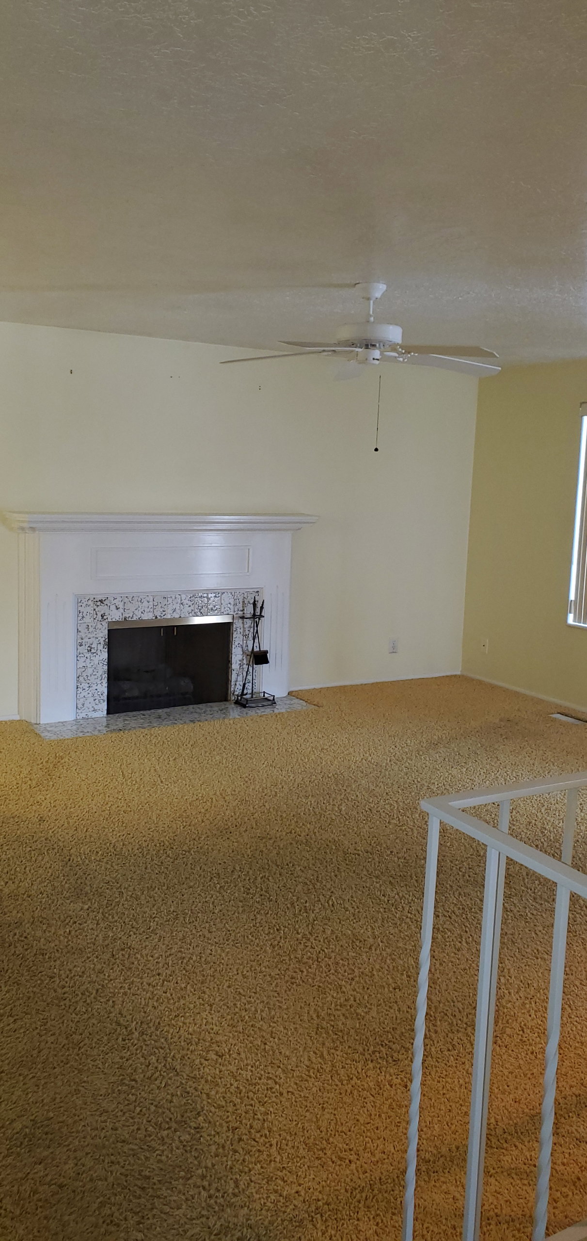Living area featuring a fireplace with a white mantel and a light-colored, patterned stone surround