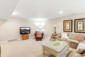 Spacious carpeted room featuring recessed lighting and neutral wall tones