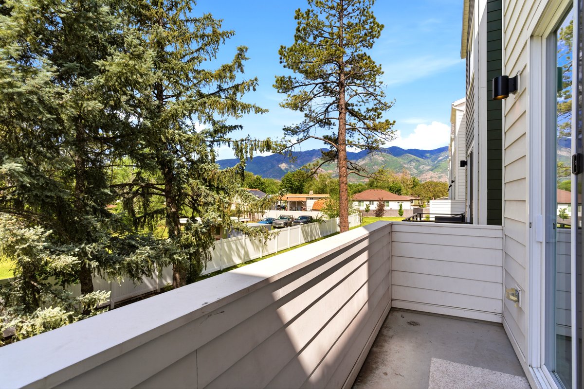 Private balcony featuring horizontal siding and a full glass sliding door
