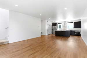 Open-concept living space featuring wood-finish flooring and recessed lighting
