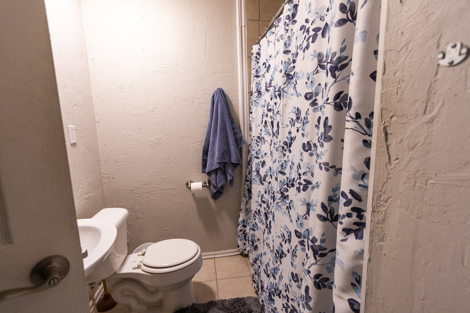 Bathroom with white toilet and tiled flooring