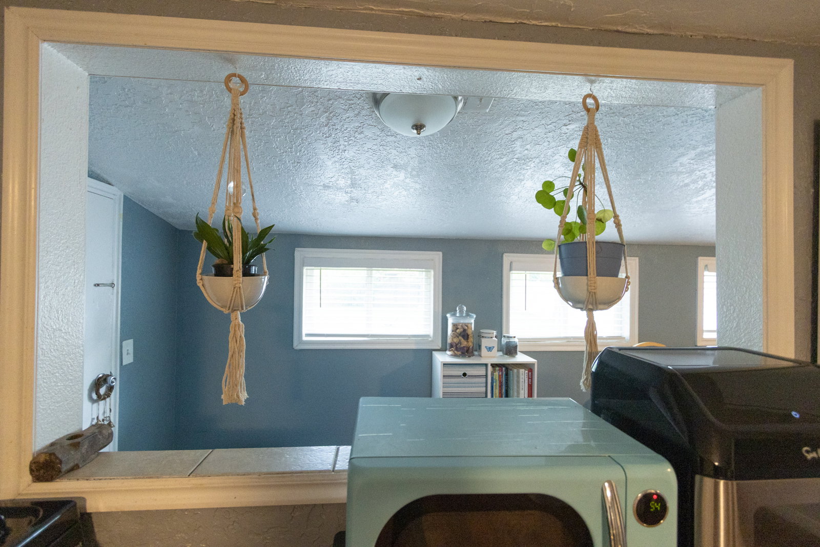 Pass-through window with a tiled countertop and white trim
