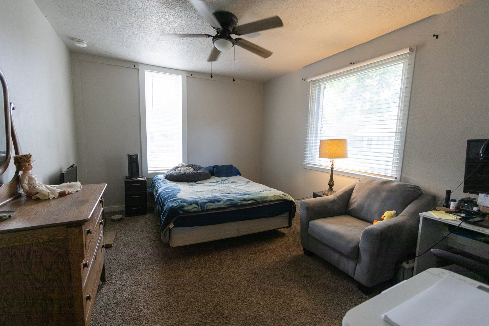 Bedroom featuring carpeted flooring and a ceiling fan with integrated lighting