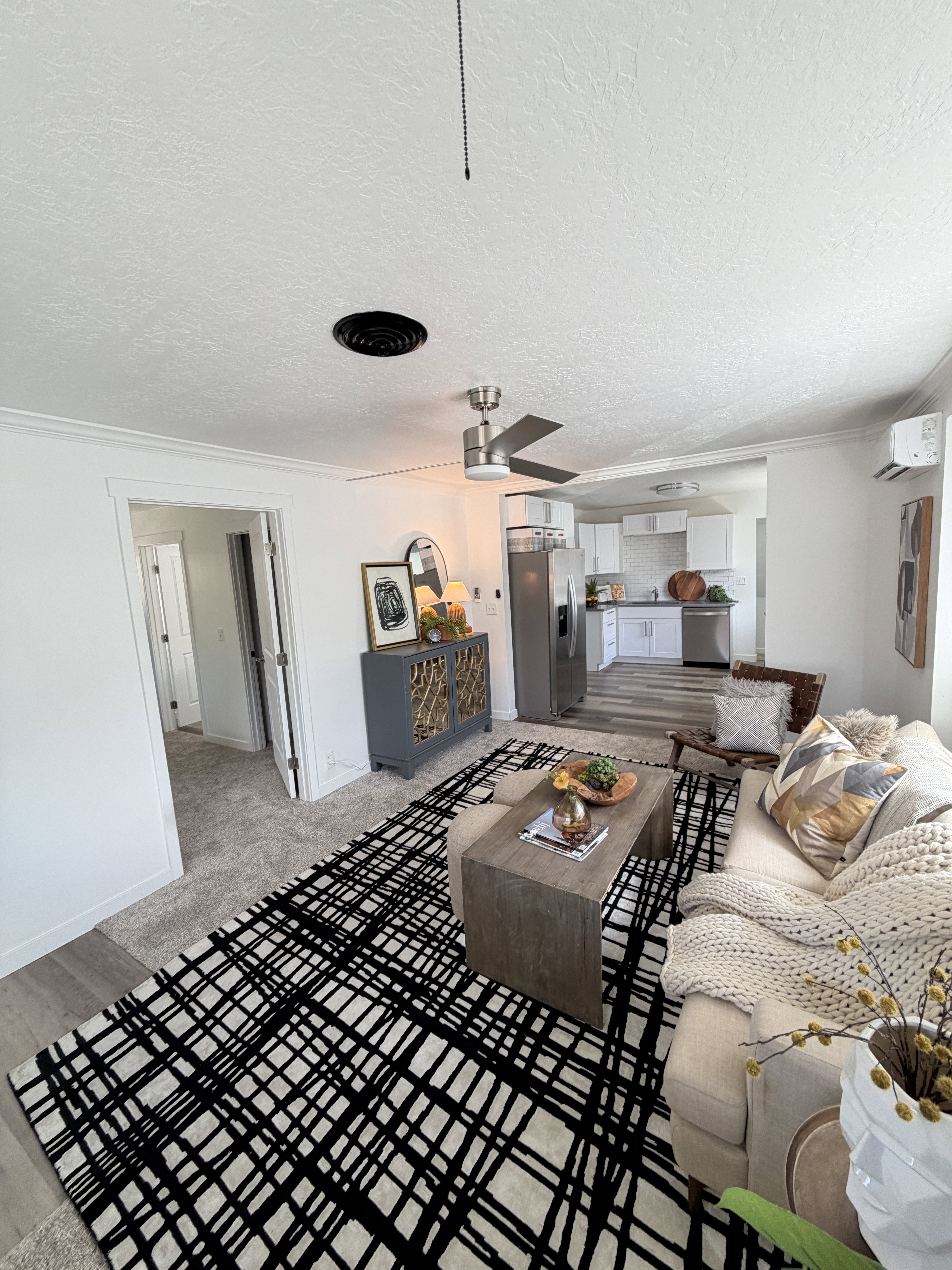 Open concept living area with recessed lighting, ceiling fan, and wood-finish flooring