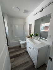 White vanity with shaker-style cabinetry, an integrated sink, and brushed nickel hardware