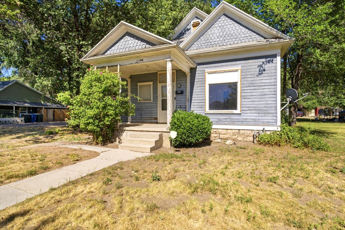 Home exterior featuring a covered porch, concrete steps, and a sidewalk