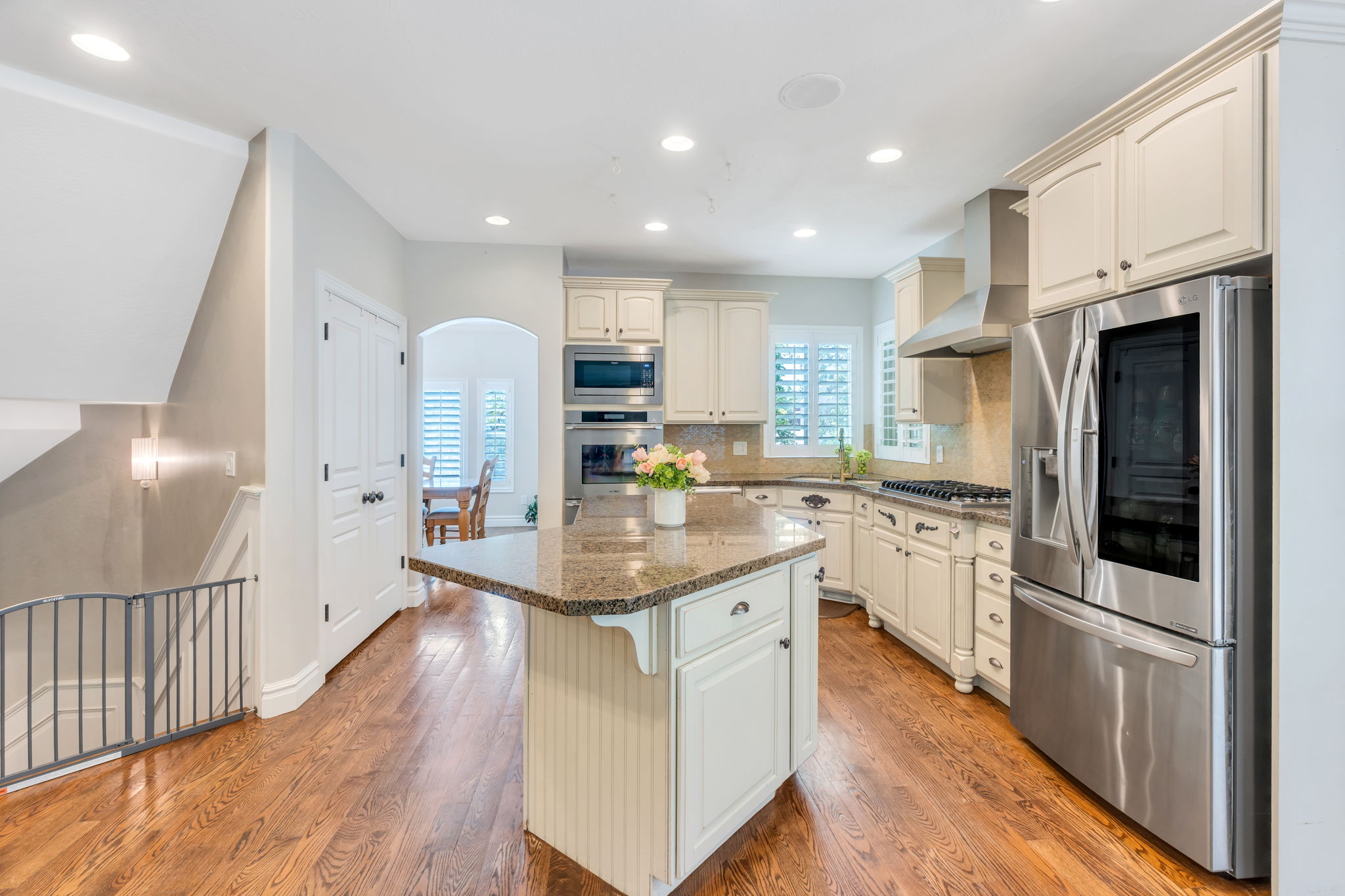 Kitchen featuring wood-finish flooring and a central island with a stone countertop