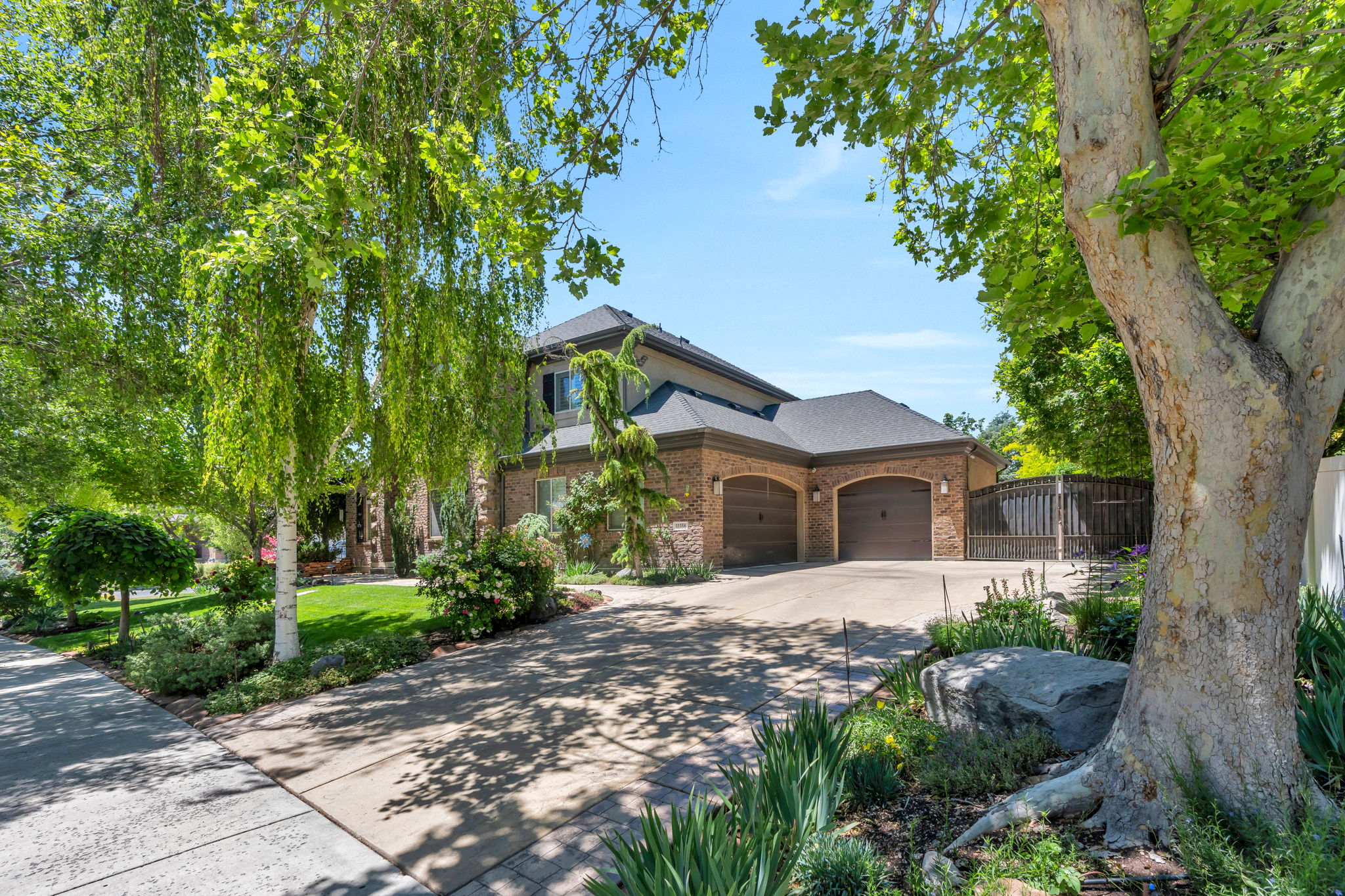 Brick and stucco exterior with a multi-gabled roofline